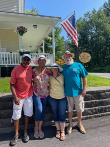 Four Guests posing in front of the Inn